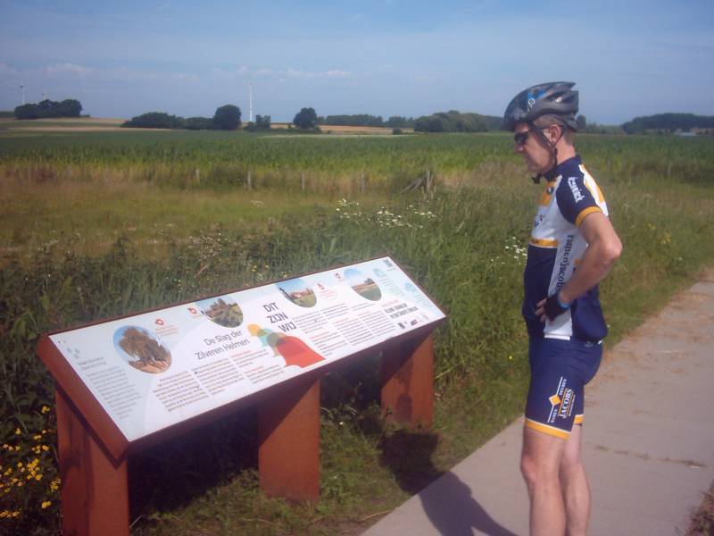 Helmen-memoriaal
We zijn er! (En niemand van de groep die protesteert als we stoppen ;-) Pit bekijkt eerste het infobord van het Helmenveld in Halen. 

